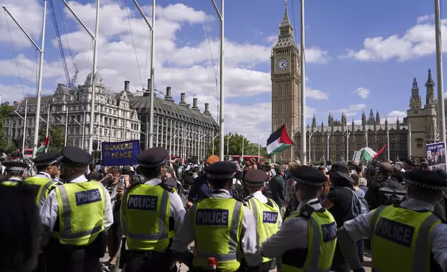 Police officers patrol during demonstrator during a protest in support of the Palestinian People in Gaza, in Parliament Square, in London, Saturday, Aug. 9, 2025.(AP Photo/Alberto Pezzali)