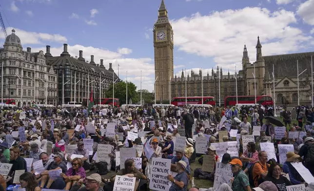 Demonstrators hold placards during a protest in support of the Palestinian People in Gaza, in Parliament Square, in London, Saturday, Aug. 9, 2025.(AP Photo/Alberto Pezzali)