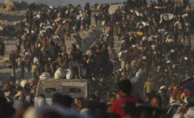 Palestinians carry sacks of flour unloaded from a humanitarian aid convoy that reached Gaza City from the northern Gaza Strip, Sunday, Aug. 24, 2025. (AP Photo/Abdel Kareem Hana)