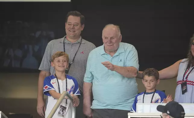 American former Atlanta Braves professional baseball player Bobby Cox waves to the crowd before a baseball game Friday, Aug. 22, 2025, in Atlanta. (AP Photo/Brynn Anderson)