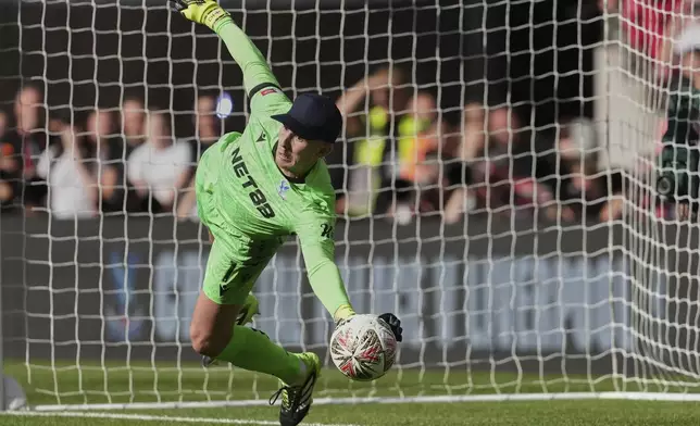 Crystal Palace's goalkeeper Dean Henderson saves during penalty shootout during the FA Community Shield final soccer match between Liverpool and Crystal Palace at Wembley Stadium in London,Sunday, Aug. 10, 2025. (AP Photo/Dave Shopland)
