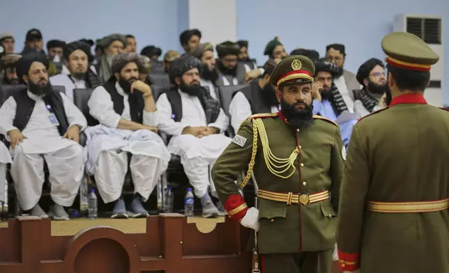 Soldiers affiliated to the Defence Ministry stand in guard during a meeting of delegates from across Afghanistan marking the start of celebrations of the fourth anniversary of the U.S. withdrawal and the start of Taliban rule, at Loya Jirga Hall in Kabul, Friday, Aug. 15, 2025. (AP Photo/Siddiqullah Alizai)
