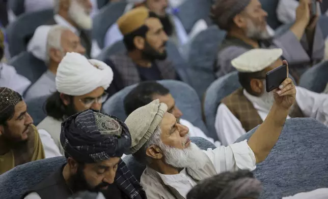 Taliban delegates from across the country gather during a meeting that opens celebrations marking the fourth anniversary of the U.S. withdrawal and the start of Taliban rule, at the Loya Jirga Hall in Kabul, Afghanistan, Friday, Aug. 15, 2025. (AP Photo/Siddiqullah Alizai)