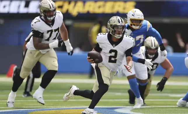 New Orleans Saints quarterback Spencer Rattler (2) runs against the Los Angeles Chargers during the first half of a preseason NFL football game Sunday, Aug. 10, 2025, in Inglewood, Calif. (AP Photo/Eric Thayer)