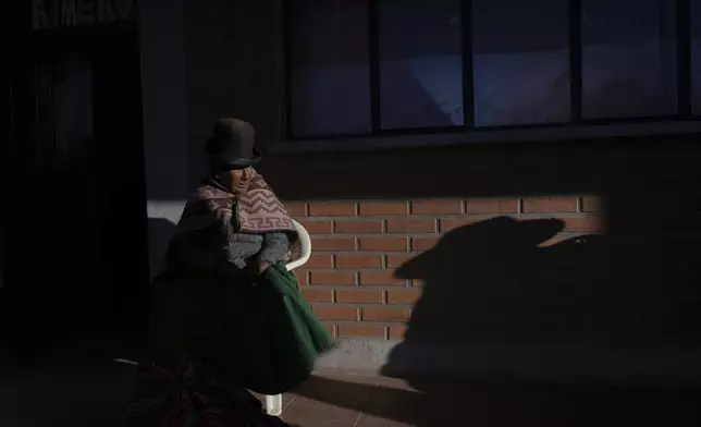 A voter sits at a polling station during general elections in Jesus de Machaca, Bolivia, Sunday, Aug. 17, 2025. (AP Photo/Juan Karita)