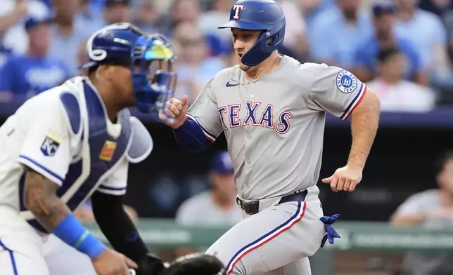 Texas Rangers' Wyatt Langford runs home to score on a single by Marcus Semien during the second inning of a baseball game against the Kansas City Royals, Wednesday, Aug. 20, 2025, in Kansas City, Mo. (AP Photo/Charlie Riedel)