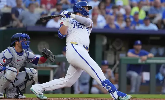 Kansas City Royals' Vinnie Pasquantino watches his three run home run during the first inning of a baseball game against the Texas Rangers, Wednesday, Aug. 20, 2025, in Kansas City, Mo. (AP Photo/Charlie Riedel)