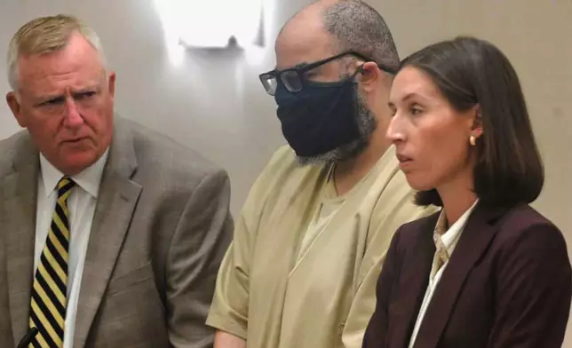 Michael Reese, center, stands with his attorneys Michael Miller and Shannon Lazier during his sentencing hearing in Connecticut Superior Court, in Danielson, Conn., on Friday, Aug. 8, 2025. (Jim Michaud/Hearst Connecticut Media via AP, Pool)