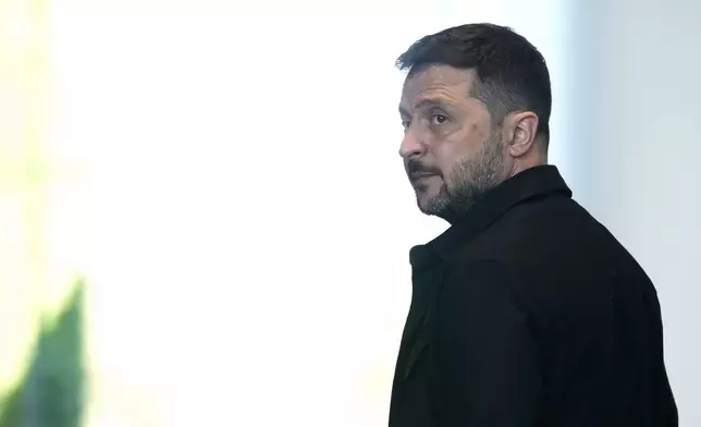 Ukrainian President Volodymyr Zelenskyy leaves after a joint press statement with German Chancellor Friedrich Merz following talks with European and U.S. leaders in Berlin, Germany, Wednesday, Aug. 13, 2025. (AP Photo/Ebrahim Noroozi)