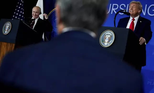 President Donald Trump listens as Russia's President Vladimir Putin speaks during a news conference at Joint Base Elmendorf- Richardson, Friday, Aug. 15, 2025, in Anchorage, Alaska. (AP Photo/Julia Demaree Nikhinson)