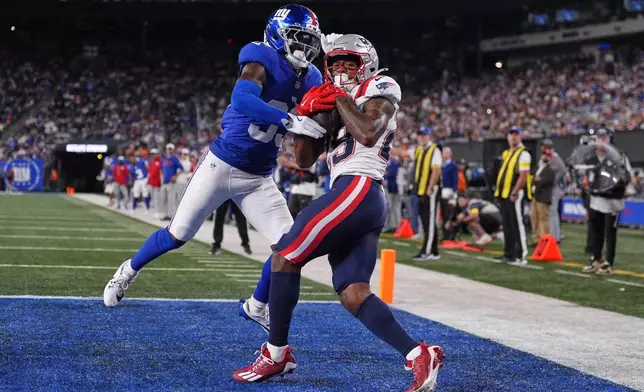 New England Patriots wide receiver Jeremiah Webb (29) makes a touchdown catch against New York Giants cornerback Dee Williams (33) during the second quarter of an NFL football game, Thursday, Aug. 21, 2025, in East Rutherford, N.J. (AP Photo/Yuki Iwamura)