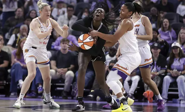 Golden State Valkyries' Laeticia Amihere, center, is fouled by Phoenix Mercury's Alyssa Thomas, center right, during the first half of a WNBA basketball game in San Francisco on Tuesday, Aug. 19, 2025. (Scott Strazzante/San Francisco Chronicle via AP)