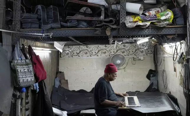 A man works at a leather factory at Dharavi in Mumbai, India, Thursday, Aug. 7, 2025. (AP Photo/Rajanish Kakade)