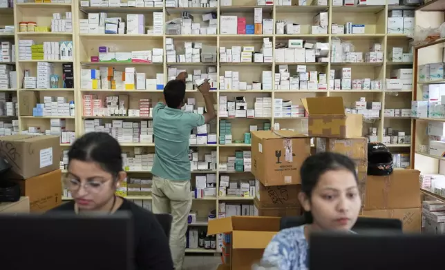 An employee sorts medicines in a medicine wholesale shop in Guwahati, India, Thursday, Aug. 7, 2025. (AP Photo/Anupam Nath)