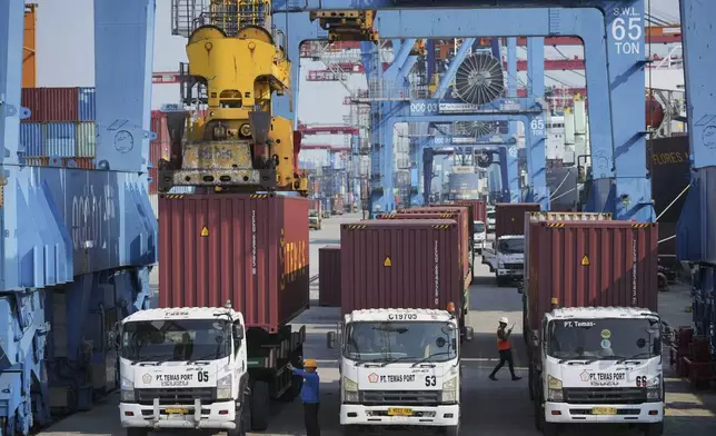 A crane unloads a shipping container from a truck at IPC Container Terminal at Tanjung Priok Port in Jakarta, Indonesia, Wednesday, Aug. 6, 2025. (AP Photo/Achmad Ibrahim)