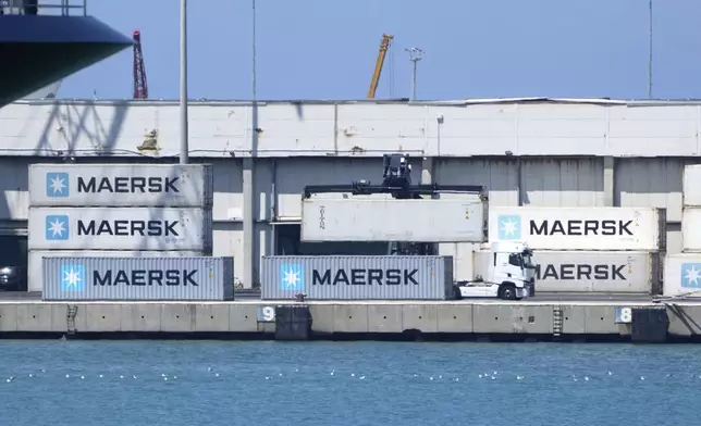 A container is loaded on a truck at the Civitavecchia Harbour, Italy, Thursday, Aug. 7, 2025. (AP Photo/Gregorio Borgia)