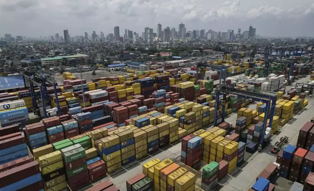 A truck navigates along stacks of containers at the Manila North Harbour Port in Manila, Philippines on Thursday, Aug. 7, 2025. (AP Photo/Aaron Favila)