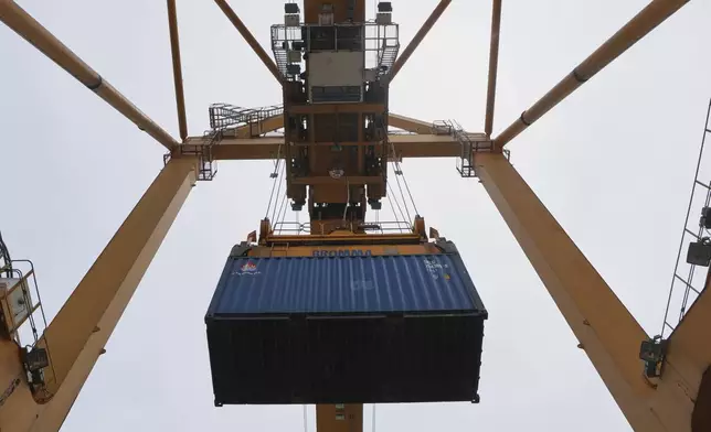 A crane works on stacks of containers at the Bangkok Port in Bangkok, Thailand, Wednesday, Aug. 6, 2025. (AP Photo/Sakchai Lalit)
