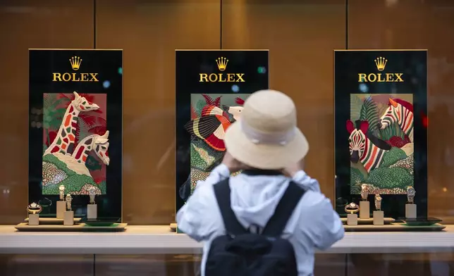 A person looks at watches made by Swiss watch brand Rolex, Thursday, Aug. 7, 2025, in New York. (AP Photo/Yuki Iwamura)
