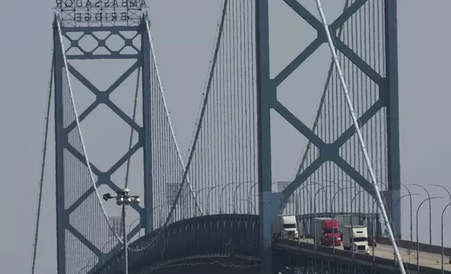 Trucks enter the United States across the Ambassador Bridge from Windsor, Ontario, Thursday, Aug. 7, 2025, in Detroit. (AP Photo/Paul Sancya)