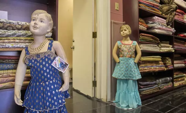 Imported Indian handmade hard embroidered children's dresses are displayed at Sona Chaandi, one of the first Indian boutiques in "Little India," in Artesia, Calif., Thursday, Aug. 7, 2025. (AP Photo/Damian Dovarganes)