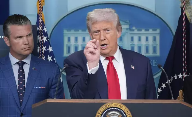 President Donald Trump speaks with reporters in the James Brady Press Briefing Room at the White House, Monday, Aug. 11, 2025, in Washington, as Secretary of Defense Pete Hegseth looks on. (AP Photo/Alex Brandon)