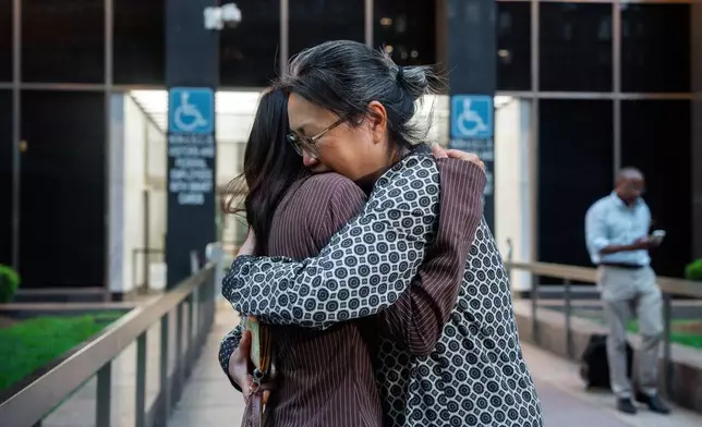 Yeonsoo Go, a Purdue student who was detained by immigration authorities in Manhattan last week, embraces her mother after being released from immigration custody, Monday, Aug. 4, 2025, in New York. (AP Photo/Olga Fedorova)