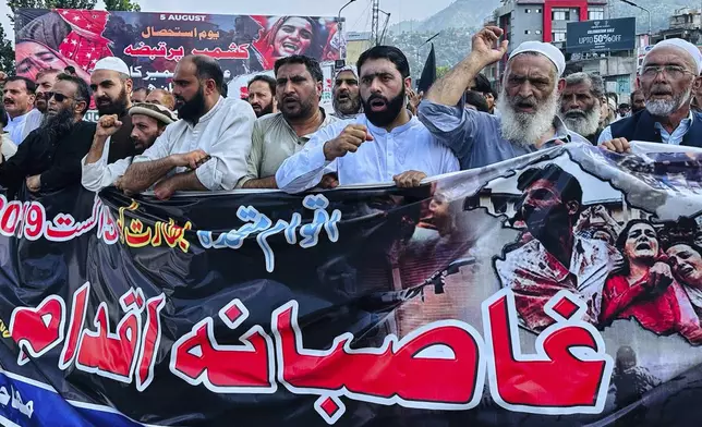 Members of a civil society 'Muhajireen Jammu and Kashmir' chant anti India slogans in Muzaffarabad, Pakistan, Tuesday, Aug. 5, 2025, during a rally to mark the sixth anniversary of India's revocation of the disputed region's semi-autonomous status. (AP Photo/M.D. Mughal)