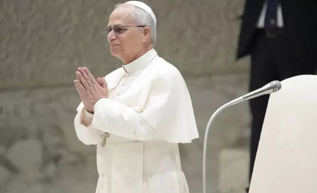 Pope Leo XIV waves as he arrives for his weekly general audience, at The Vatican, Wednesday, Aug.20, 2025. (AP Photo/Gregorio Borgia)