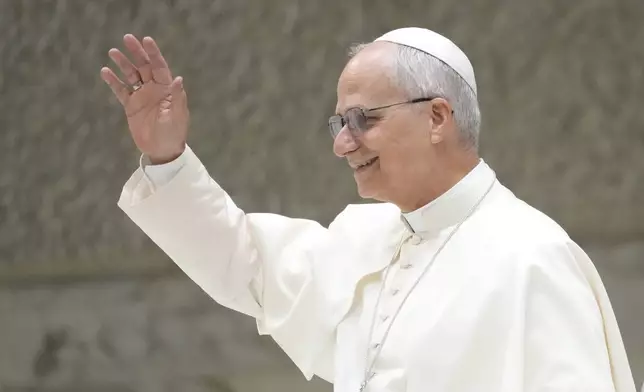 Pope Leo XIV waves as he arrives for his weekly general audience, at The Vatican, Wednesday, Aug.20, 2025. (AP Photo/Gregorio Borgia)
