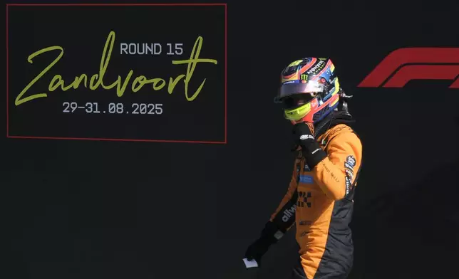 McLaren driver Oscar Piastri of Australia celebrates his pole position after the qualifying session ahead of the Formula One Dutch Grand Prix at the Zandvoort racetrack in Zandvoort, Netherlands, Saturday, Aug. 30, 2025. (AP Photo/Patrick Post)