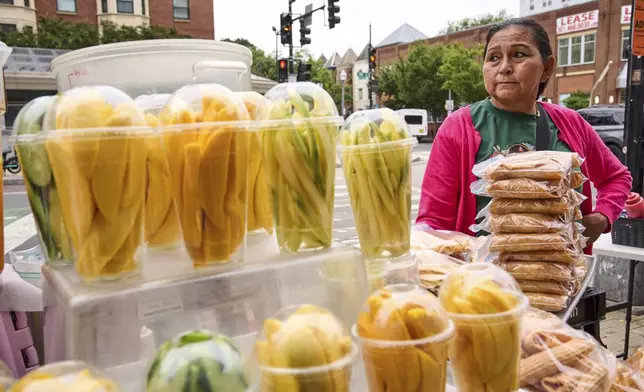 Gloria Gomez, 58, of Washington, tends her fruit stand, Tuesday, Aug. 19, 2025, as she waits for customers in the Columbia Heights neighborhood of northwest Washington. "Business is worse now than it was during the pandemic," says Gomez, "over the last three weeks it's been less and less." (AP Photo/Jacquelyn Martin)