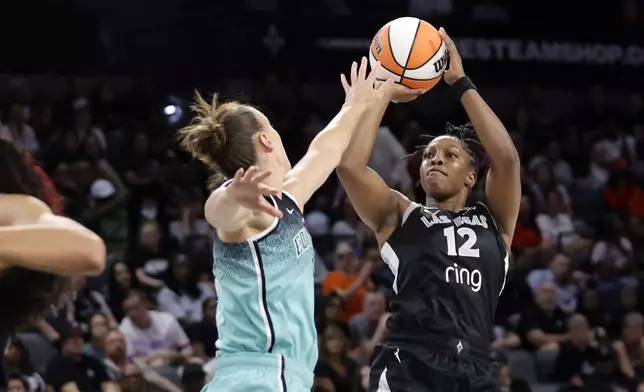 Las Vegas Aces guard Chelsea Gray (12) shoots over New York Liberty forward Stephanie Talbot during the first half of a WNBA basketball game, Wednesday, Aug. 13, 2025, in Las Vegas. (Steve Marcus/Las Vegas Sun via AP)