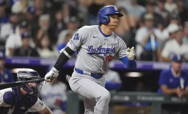 Los Angeles Dodgers; Shohei Ohtani drives in a run while hitting into a force play against Colorado Rockies relief pitcher Nick Anderson in the seventh inning of a baseball game, Tuesday, Aug. 19, 2025, in Denver. (AP Photo/David Zalubowski)