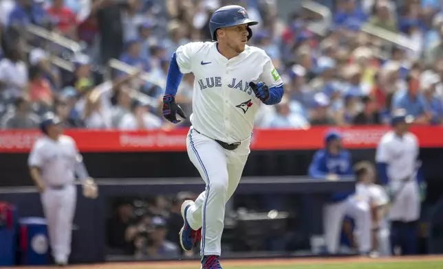 Toronto Blue Jays' Myles Straw (3) hits a home run against the Texas Rangers during the second inning of a baseball game in Toronto, Saturday, Aug. 16, 2025. (Tara Walton/The Canadian Press via AP)