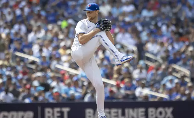 Toronto Blue Jays' Eric Lauer (56) pitches against the Texas Rangers during the first inning of a baseball game in Toronto, Saturday, Aug. 16, 2025. (Tara Walton/The Canadian Press via AP)