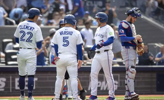 Toronto Blue Jays' Myles Straw (3) celebrates his home run with teammates Ernie Clement (22) and Daulton Varsho (5) during the second inning of a baseball game against the Texas Rangers in Toronto, Saturday, Aug. 16, 2025. (Tara Walton/The Canadian Press via AP)