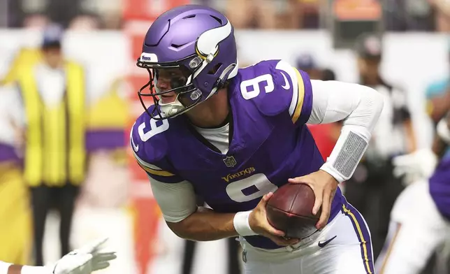 Minnesota Vikings quarterback J.J. McCarthy takes a snap during the first half of an NFL preseason football game against the Houston Texans, Saturday, Aug. 9, 2025, in Minneapolis. (AP Photo/Matt Krohn)