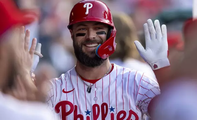 Philadelphia Phillies' Weston Wilson celebrates hitting a solo home run with teammates during the third inning of a baseball game against the Atlanta Braves, Saturday, Aug. 30, 2025, in Philadelphia. (AP Photo/Chris Szagola)