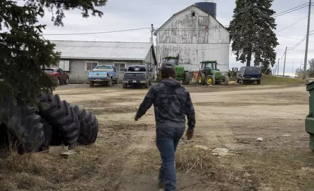Devon Wells, a junior at Perry Central High School, walks across Halo Farms, where he works, on March 12, 2025, in Perry, N.Y. (AP Photo/Lauren Petracca)