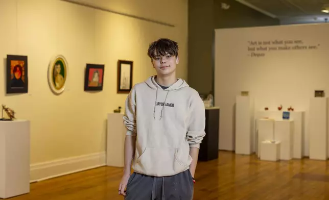 Briar Townes, a senior at Perry Central High School, poses for a portrait inside the Arts Council for Wyoming County, where he has art displayed as part of an All-County High School Arts Show, on March 12, 2025, in Perry, N.Y. (AP Photo/Lauren Petracca)