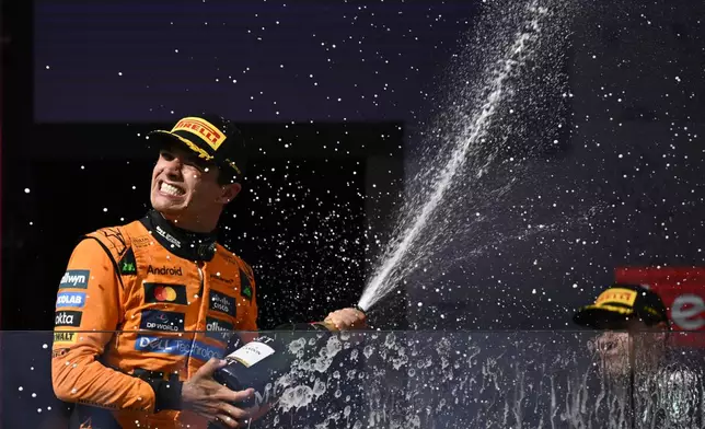 McLaren driver Lando Norris of Britain celebrates on the podium after winning the Hungarian Formula One Grand Prix race at the Hungaroring racetrack in Mogyorod, Hungary, Sunday, Aug. 3, 2025. (AP Photo/Denes Erdos)