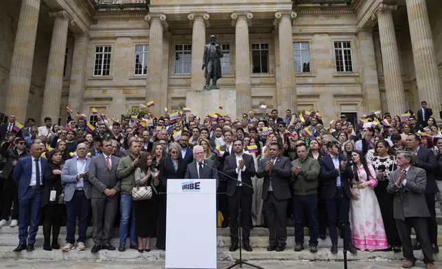 Miguel Uribe Londono, father of slain presidential candidate Miguel Uribe Turbay, reads a statement to officially announce his bid for the presidency in Bogota, Colombia, Tuesday, Aug. 26, 2025. (AP Photo/Fernando Vergara)