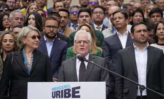 Miguel Uribe Londono, father of slain presidential candidate Miguel Uribe Turbay, reads a statement to officially announce his bid for the presidency in Bogota, Colombia, Tuesday, Aug. 26, 2025. (AP Photo/Fernando Vergara)