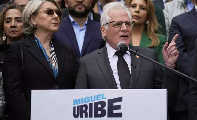 Miguel Uribe Londono, father of slain presidential candidate Miguel Uribe Turbay, reads a statement to officially announce his bid for the presidency in Bogota, Colombia, Tuesday, Aug. 26, 2025. (AP Photo/Fernando Vergara)