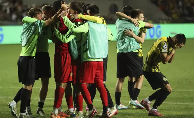 Players embrace Kairat's goalkeeper Temirlan Anarbekov after winning the Champions League playoff second leg soccer match between Kairat and Celtic at Ortalyk stadium in Almaty, Kazakhstan, Wednesday, Aug. 27, 2025. (AP Photo/Alikhan Sariyev)
