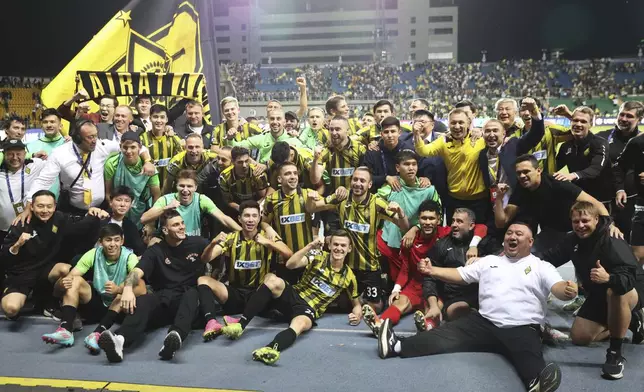 Kairat players celebrate after winning the Champions League playoff second leg soccer match between Kairat and Celtic at Ortalyk stadium in Almaty, Kazakhstan, Wednesday, Aug. 27, 2025. (AP Photo/Alikhan Sariyev)