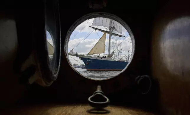 The barkentine Antigua passes as hundreds of tall ships sailed into the Dutch capital's harbor for the 10th edition of SAIL, in Amsterdam, Netherlands, Wednesday, Aug. 20, 2025. (AP Photo/Peter Dejong)