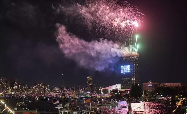 Fireworks were set off after hundreds of tall ships sailed into the Dutch capital's harbor for the 10th edition of SAIL, in Amsterdam, Netherlands, Wednesday, Aug. 20, 2025. (AP Photo/Peter Dejong)