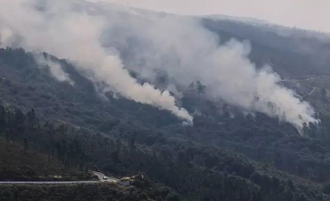 Plumes of smoke rise from a forest fire in Maceda, northwestern Spain, Wednesday, Aug. 13, 2025. (AP Photo/Lalo Villar)